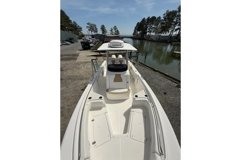 Slide: The Image of 2019 Edgewater 262CC boat on trailer in outdoor storage area. - 1