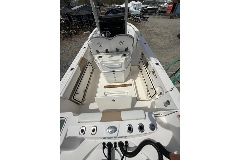 Slide: The Image of 2019 Edgewater 262CC boat interior with Garmin navigation system and seating. - 10