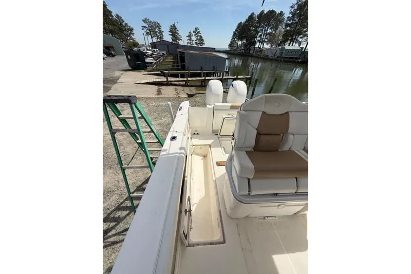 Slide: The Image of 2019 Edgewater 262CC boat interior with steering console and seating area. - 11