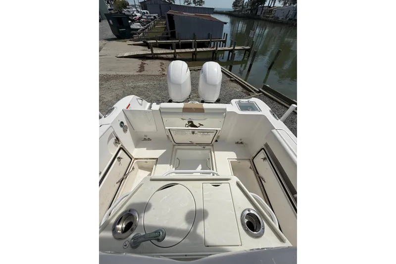 Slide: The Image of 2019 Edgewater 262CC boat interior with storage compartments and control panel. - 13