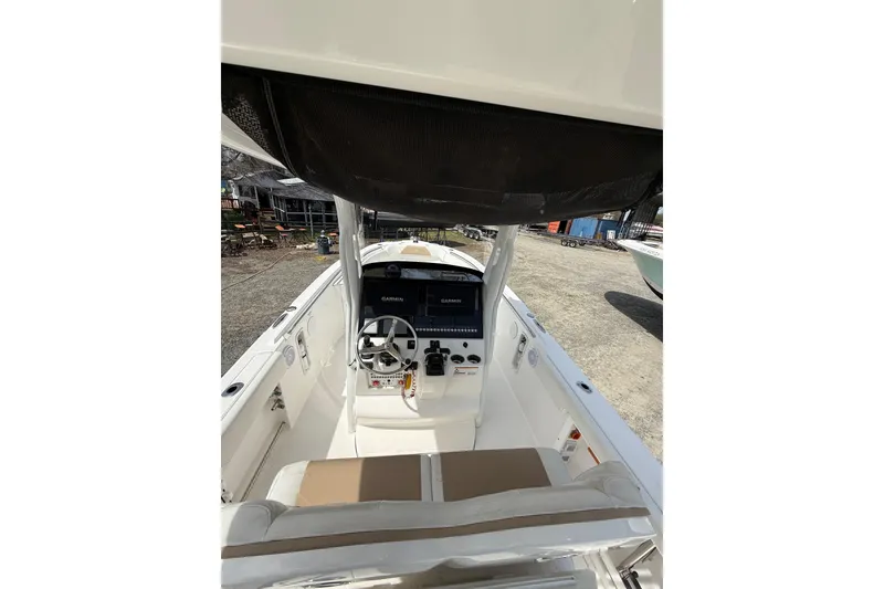 Slide: The Image of 2019 Edgewater 262CC boat interior with open door revealing compact marine toilet. - 7
