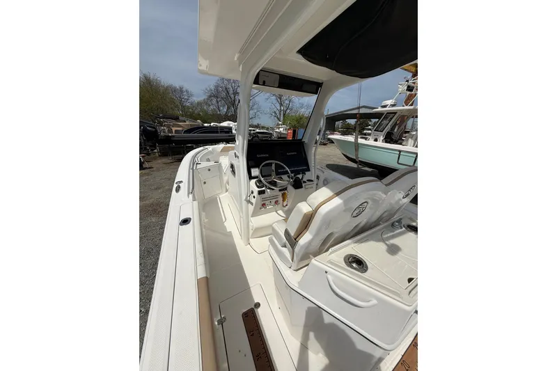 Slide: The Image of 2019 Edgewater 262CC boat interior with storage compartments and cup holders. - 8