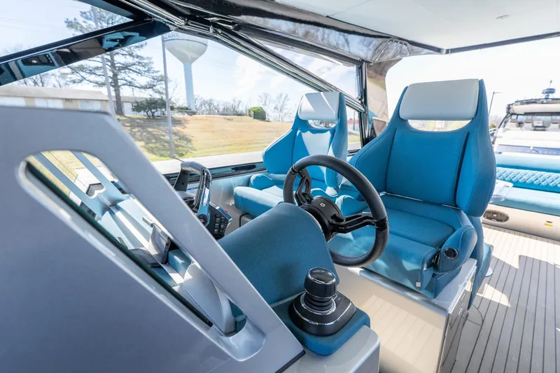 Slide: The Image of Interior of 2026 Dutch American DA 53 boat with modern blue seating and steering wheel. - 11