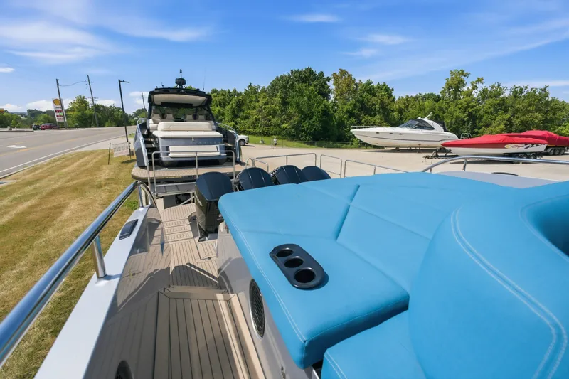 Slide: The Image of Luxurious 2026 Dutch American DA 53 yacht with blue seating, parked near a road and trees. - 75