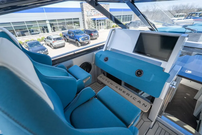 Slide: The Image of Interior of 2026 Dutch American DA 53 yacht with blue seating and modern dashboard. - 25
