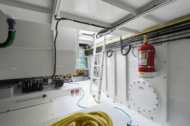 Slide: The Image of Interior of 2026 Dutch American DA 53 yacht engine room with fire extinguisher and wiring. - 67