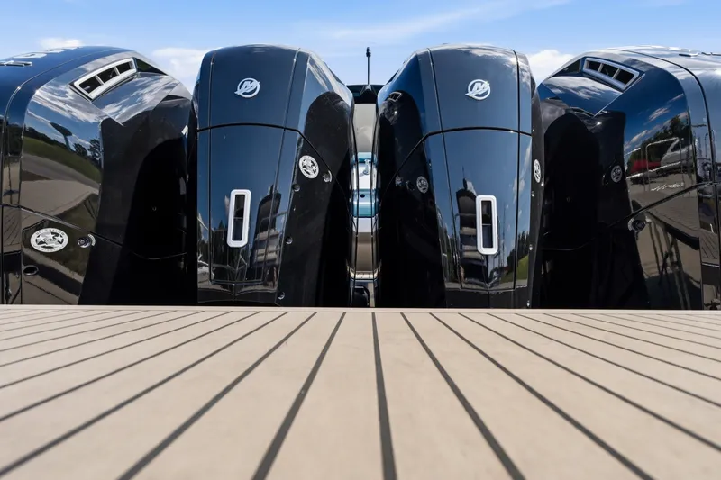Slide: The Image of Four sleek black outboard motors on a boat deck, Dutch American DA 53, 2026 model. - 22