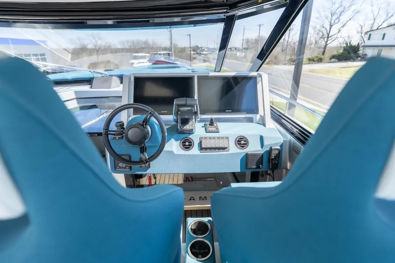 Slide: The Image of Interior view of 2026 Dutch American DA 53 boat cockpit with modern controls and blue seating. - 30