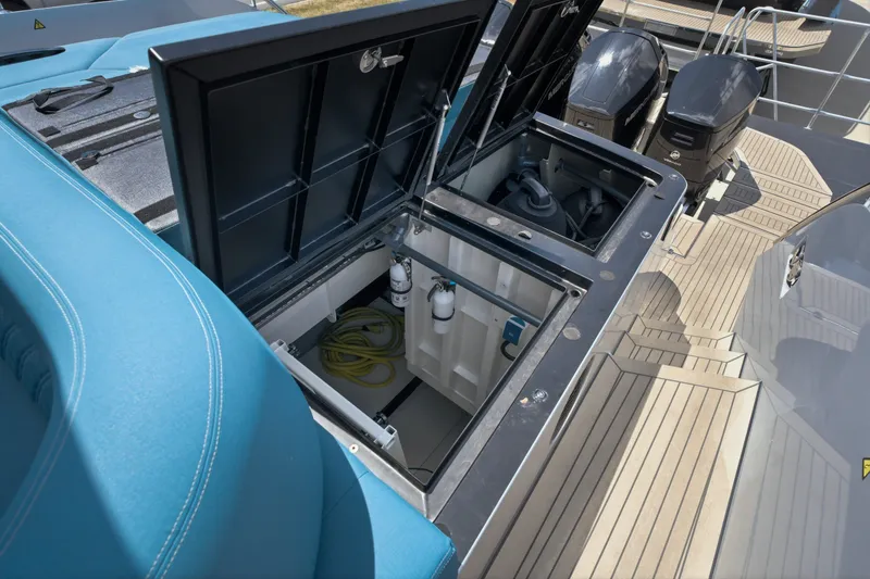 Slide: The Image of Open storage compartment on 2026 Dutch American DA 53 boat, showcasing interior equipment and engines. - 63