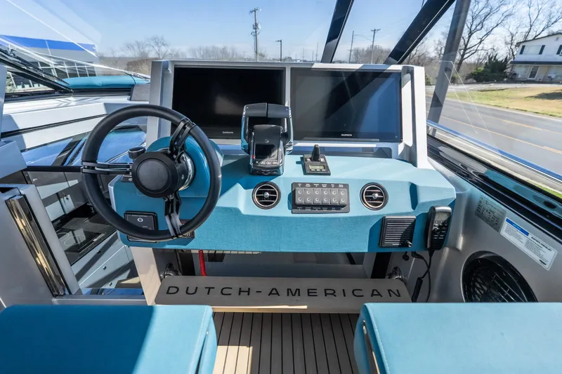 Slide: The Image of Helm of 2026 Dutch American DA 53 boat with modern controls and dual screens. - 32