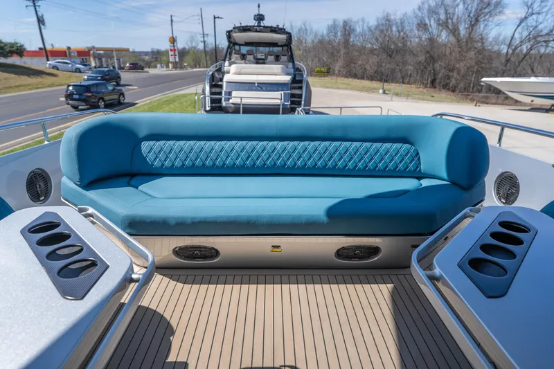 Slide: The Image of Luxurious seating area on 2026 Dutch American DA 53 boat, featuring blue upholstery and cup holders. - 34