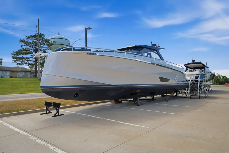 Slide: The Image of 2026 Dutch American DA 53 yacht on display in a parking lot under a clear blue sky. - 1