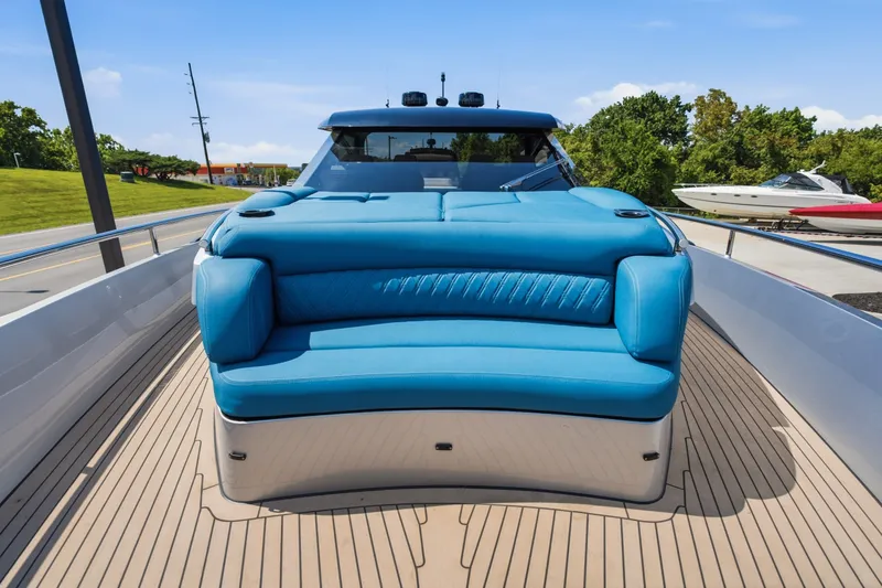 Slide: The Image of 2026 Dutch American DA 53 yacht with blue seating on deck, docked outdoors. - 55