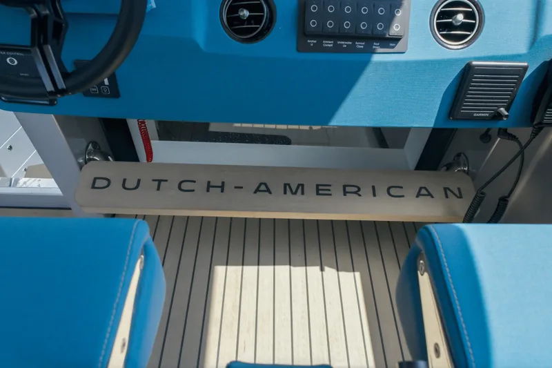 Slide: The Image of Interior of 2026 Dutch American DA 53 boat with blue seating and control panel. - 70