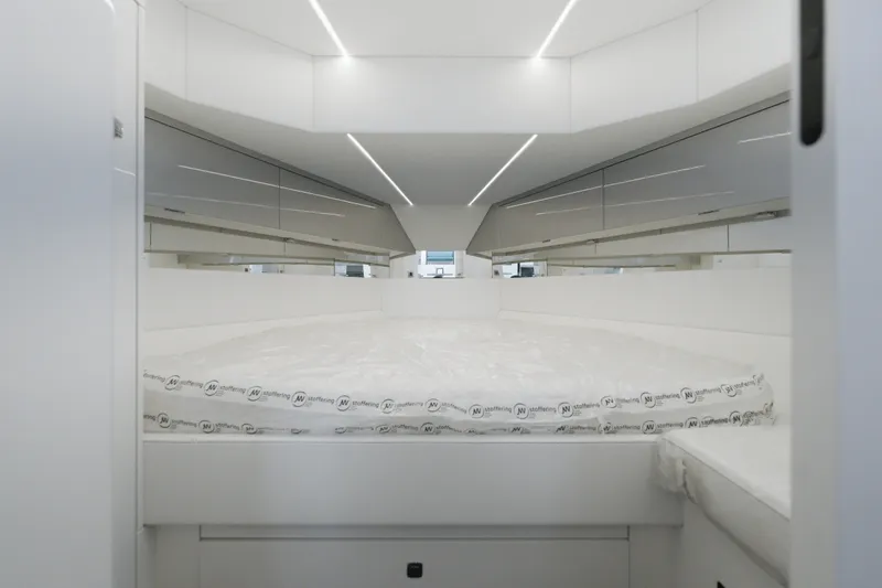 Slide: The Image of Modern interior of Dutch American DA 53, 2026 model, featuring sleek white design and comfortable bedding. - 44