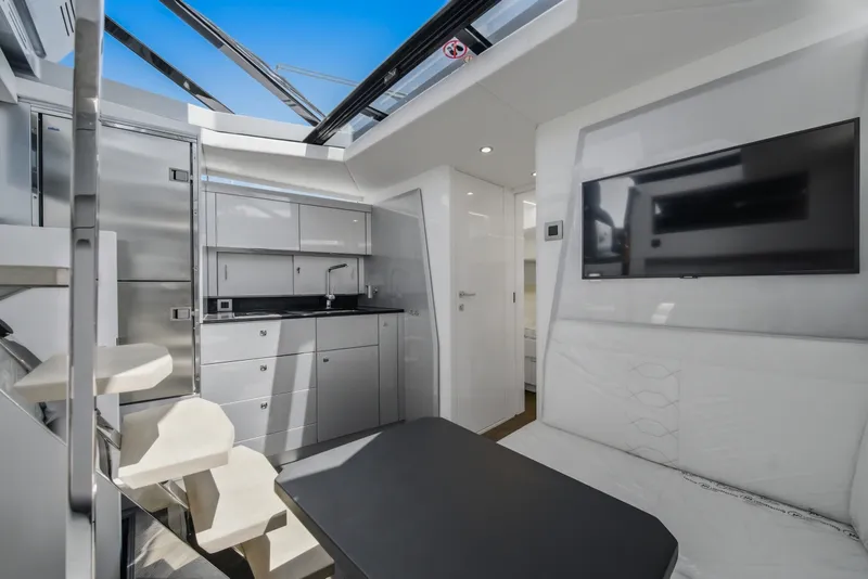 Slide: The Image of Modern yacht interior with sleek kitchen, seating area, and TV; Dutch American DA 53, 2026 model. - 41