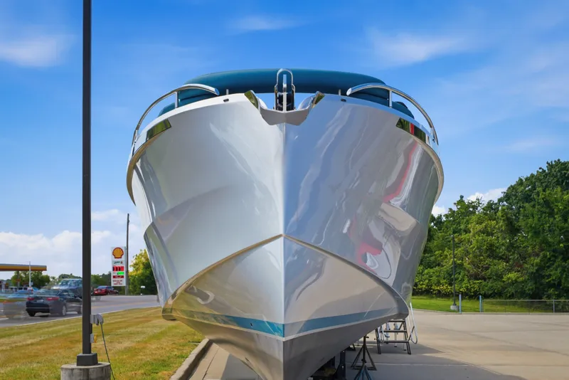 Slide: The Image of Front view of a 2026 Dutch American DA 53 boat on display outdoors. - 12