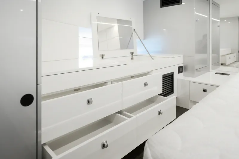 Slide: The Image of Modern white interior of Dutch American DA 53, 2026 model, featuring sleek drawers and cabinets. - 49