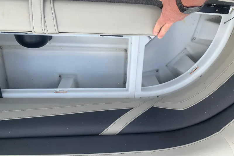 Slide: The Image of Interior storage compartment of a 2022 Barletta C22UC boat with cushioned seating. - 10