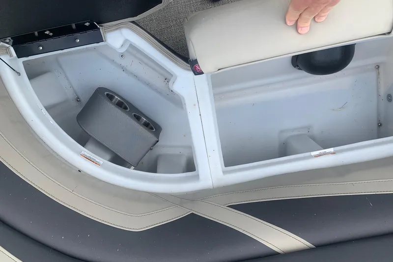 Slide: The Image of 2022 Barletta C22UC boat storage compartment with cup holders and seating. - 11