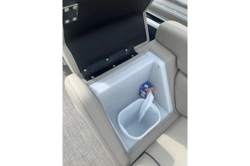 Slide: The Image of Barletta C22UC 2022 boat seat storage with open compartment and trash bin. - 12