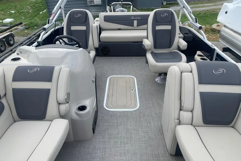 Slide: The Image of 2022 Barletta C22UC pontoon boat interior with gray and beige seating. - 5