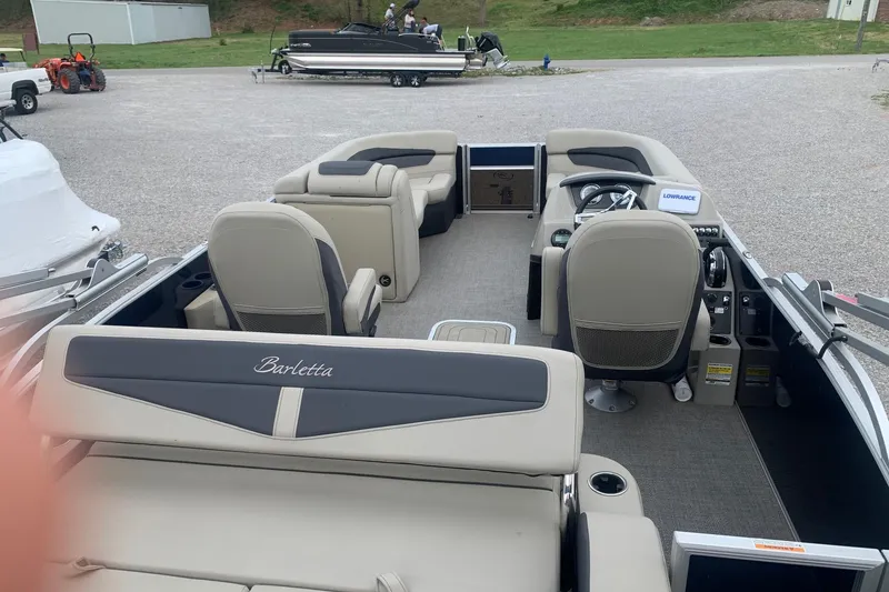 Slide: The Image of 2022 Barletta C22UC pontoon boat interior with seating and steering console. - 7