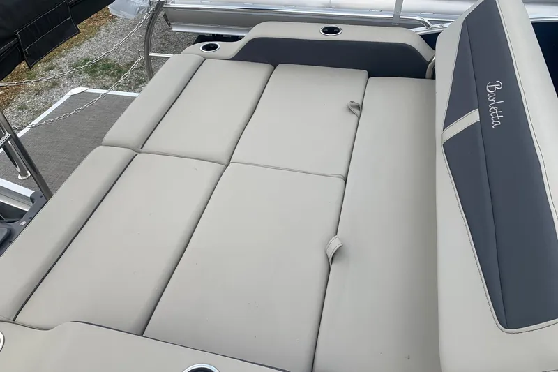 Slide: The Image of 2022 Barletta C22UC boat with spacious, cushioned seating area and cup holders. - 8