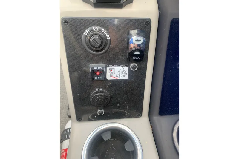 Slide: The Image of Control panel of a 2022 Barletta C22UC boat with ignition and canopy switch. - 9