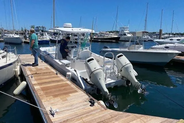 Slide: The Image of 2020 Twin Vee 260 CC SE boat docked at marina with twin engines. - 1