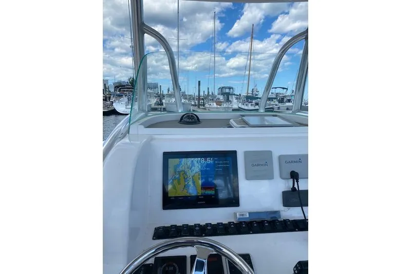 Slide: The Image of 2020 Twin Vee 260 CC SE boat dashboard with Garmin navigation system at marina. - 4