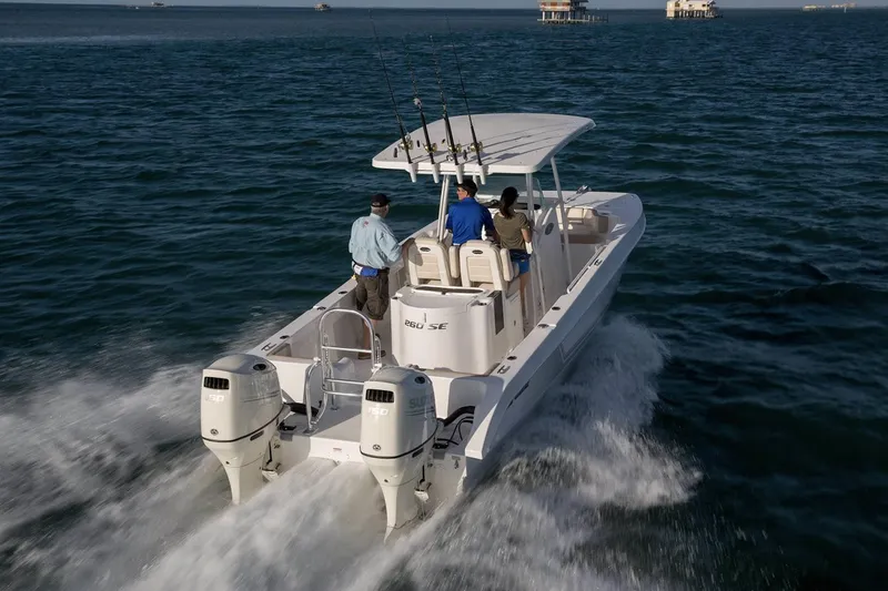 Slide: The Image of Manufacturer Provided Image: 2020 Twin Vee 260 CC SE boat cruising on open water with three passengers. - 6