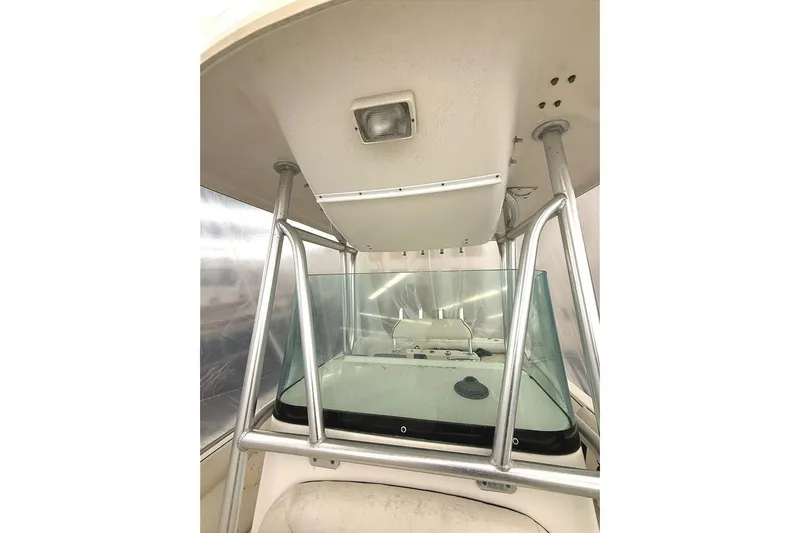 Slide: The Image of 2005 Robalo R220 Center Console boat interior with windshield and metal frame. - 10