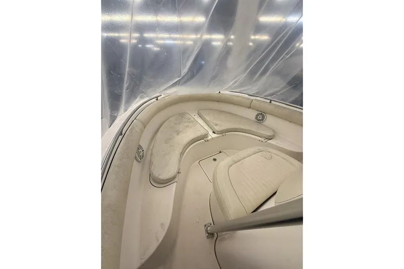 Slide: The Image of 2005 Robalo R220 Center Console boat interior with cushioned seating and speakers. - 13