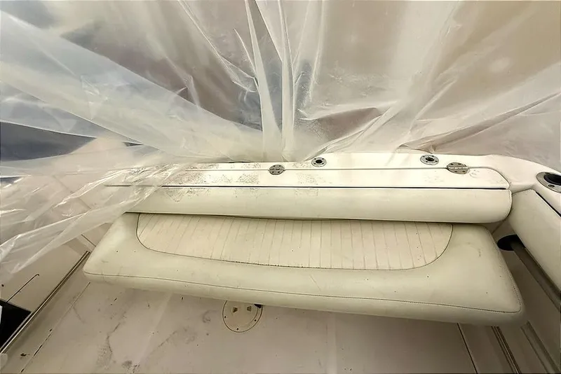 Slide: The Image of 2005 Robalo R220 Center Console boat interior with protective plastic covering. - 3