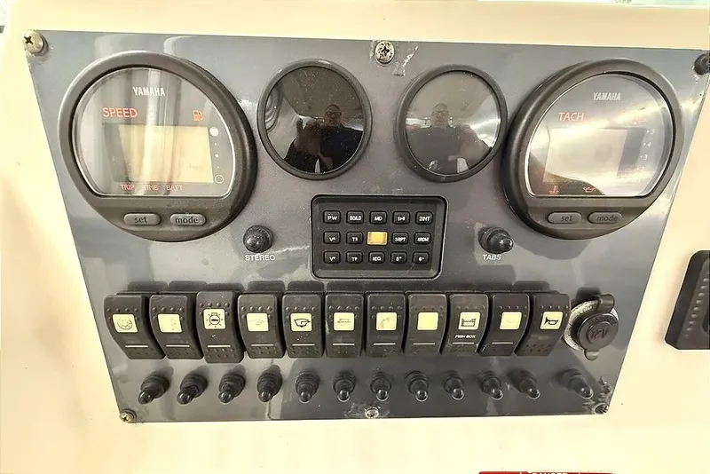 Slide: The Image of Dashboard of a 2005 Robalo R220 Center Console boat with Yamaha gauges and controls. - 6