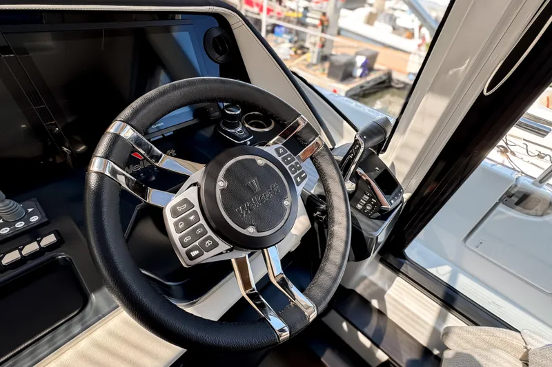 Slide: The Image of Steering wheel of 2026 Wellcraft 44 Explorer yacht, featuring modern controls and sleek design. - 28