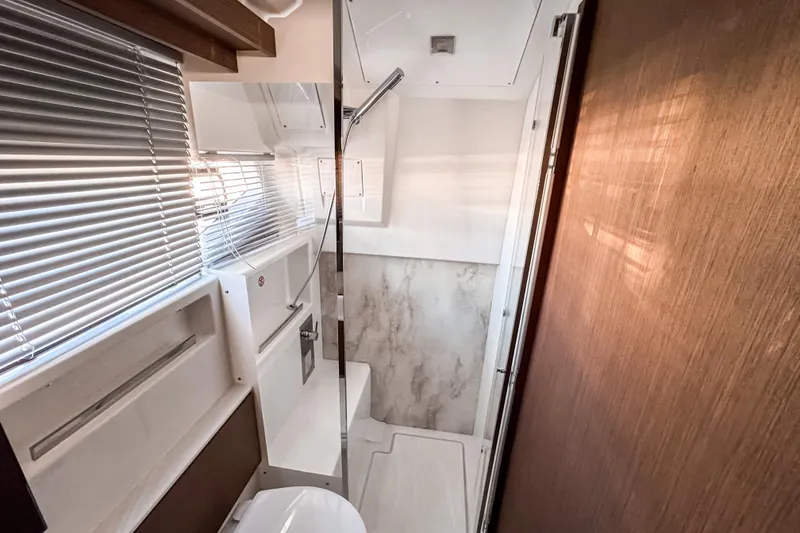 Slide: The Image of Modern bathroom interior of 2026 Wellcraft 44 Explorer yacht with sleek design and natural lighting. - 44