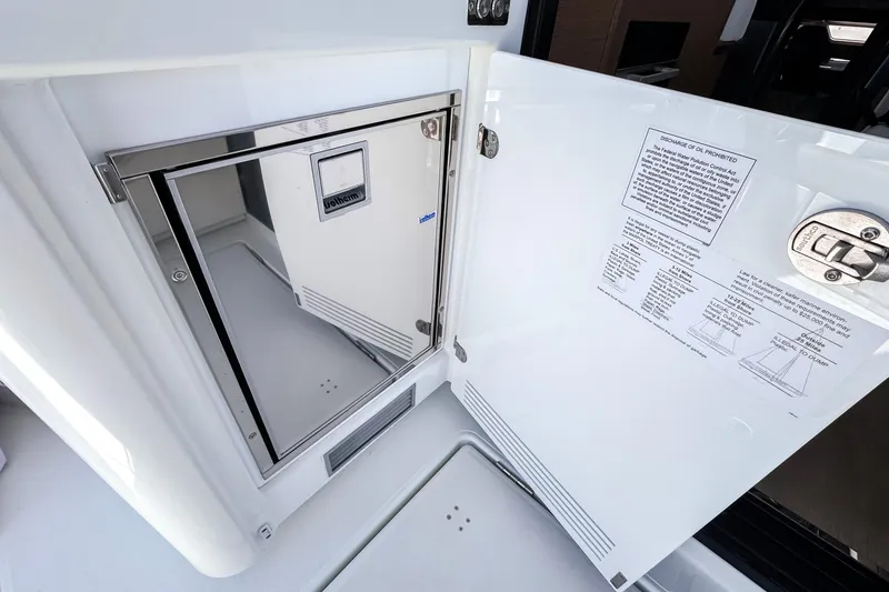 Slide: The Image of Wellcraft 44 Explorer 2026 yacht interior with open storage compartment and safety instructions. - 11