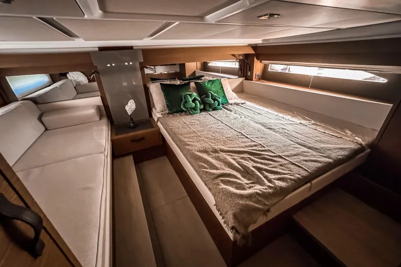 Slide: The Image of Luxurious cabin interior of 2026 Wellcraft 44 Explorer yacht, featuring cozy bed and elegant decor. - 32
