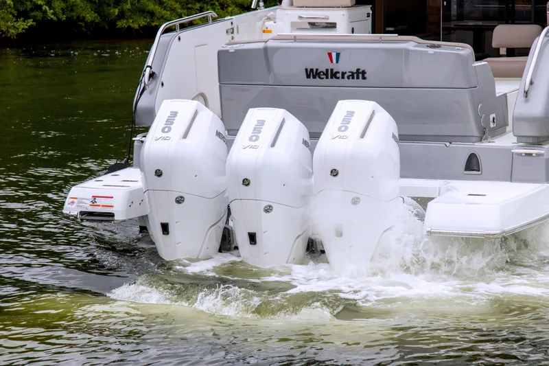 Slide: The Image of 2026 Wellcraft 44 Explorer with triple outboard engines on water. - 4