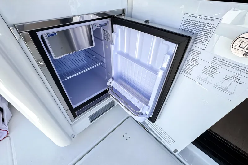 Slide: The Image of Open refrigerator on Wellcraft 44 Explorer yacht, showcasing interior storage space. - 12
