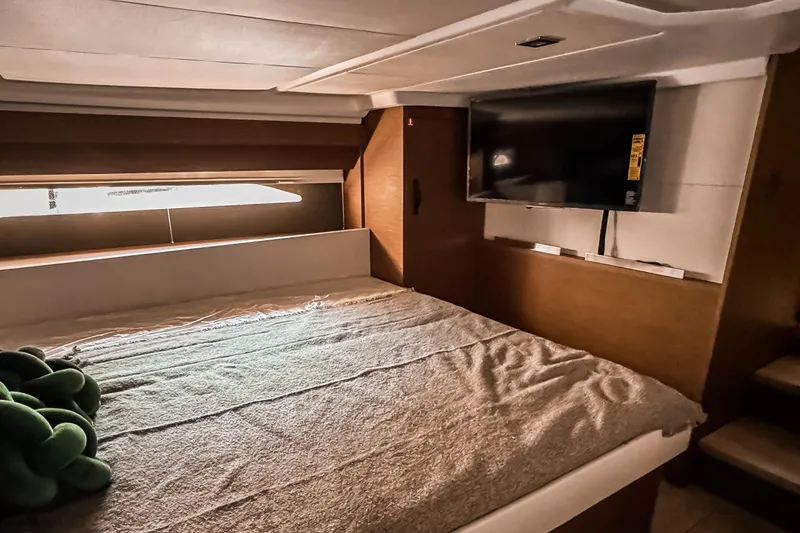 Slide: The Image of Luxurious cabin interior of 2026 Wellcraft 44 Explorer with bed and mounted TV. - 34