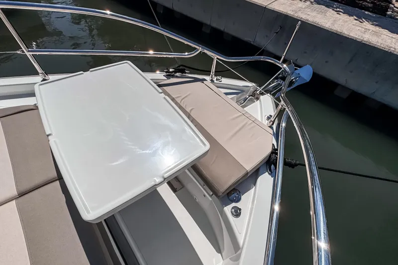 Slide: The Image of Bow seating area on 2026 Wellcraft 44 Explorer yacht, featuring cushioned seats and table. - 49