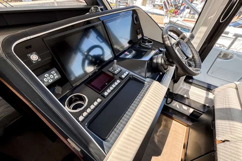 Slide: The Image of Helm of 2026 Wellcraft 44 Explorer with modern navigation displays and controls. - 27