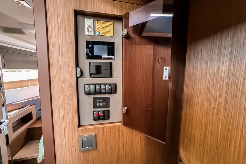 Slide: The Image of Control panel inside 2026 Wellcraft 44 Explorer yacht, featuring modern switches and wood finish. - 35