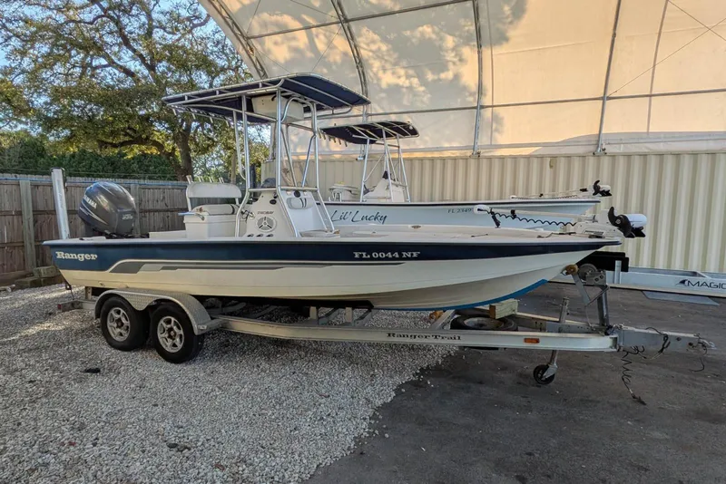 Slide: The Image of 2005 Ranger 2180 Bay Ranger boat on trailer, parked under a canopy. - 2
