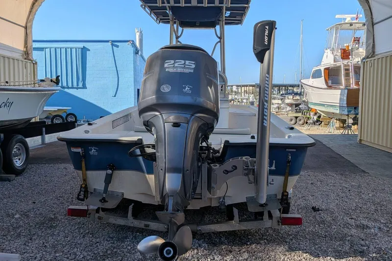 Slide: The Image of 2005 Ranger 2180 Bay Ranger boat with outboard motor in a marina setting. - 4