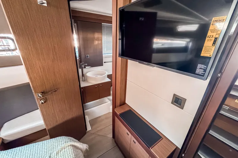 Slide: The Image of Interior of 2026 Wellcraft 44 Explorer yacht with modern bathroom and mounted TV. - 42