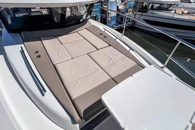 Slide: The Image of Luxury sunbathing deck on 2026 Wellcraft 44 Explorer yacht, featuring comfortable cushions. - 46